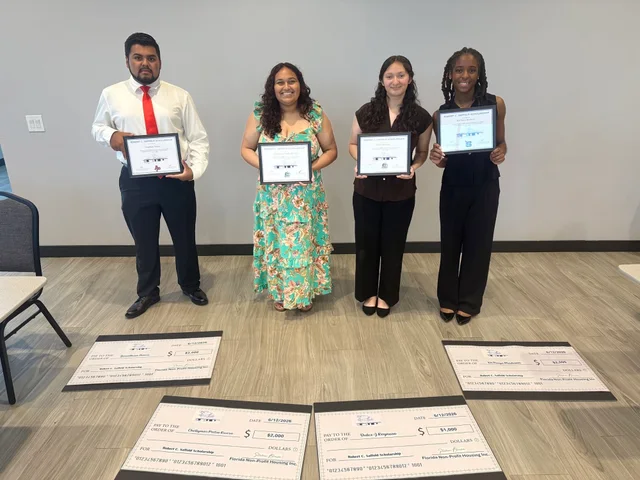 Four Robert C. Saffold scholarship recipients holding their certificates at FNPH.
